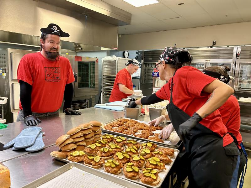 Cook Matthew Silverman watches assistant cook Elizabeth Hartman prepare samples of Nashville spicy chicken sandwiches.